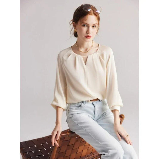 Elegant silk-blend blouse with raglan sleeves, featuring a timeless design and unique hollow-out details