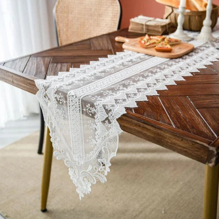 Elegant lace table runner with intricate embroidery and hollowed-out patterns, adding sophistication to any dining setting