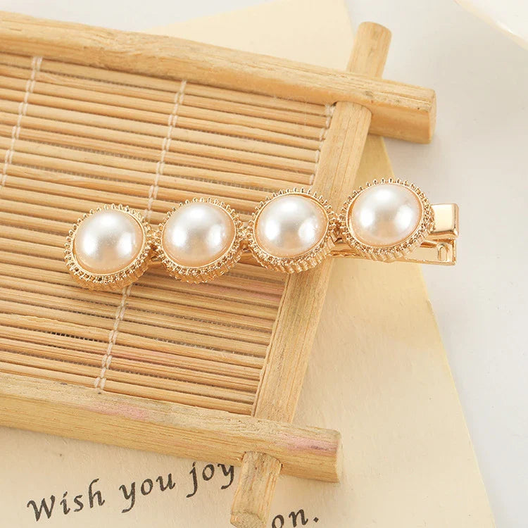 Elegant silver-toned hair clip with a beautiful pearl flower design, a timeless British-inspired accessory