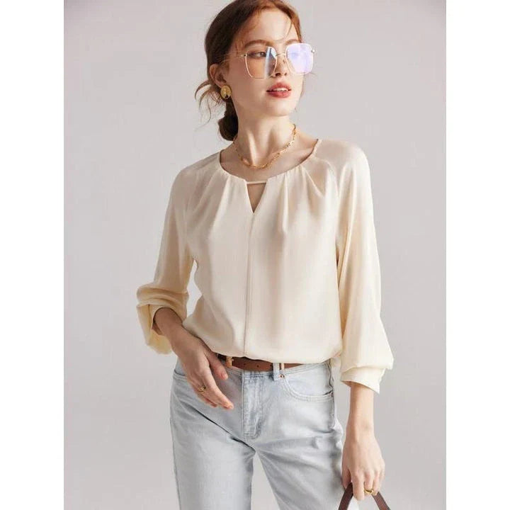 Elegant silk-blend blouse with raglan sleeves, featuring a timeless design and unique hollow-out details