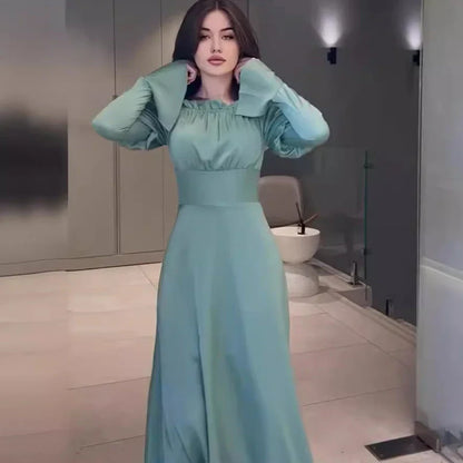 Elegant blue bubble collar dress with wooden buttons and a cinched waist, perfect for formal and casual occasions.