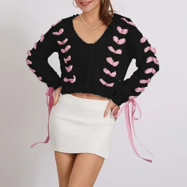 A versatile contrast V-neck tie cardigan in a soft, polyester fabric with a patchwork pattern and lace-up detail for a fashionable and comfortable layering piece.
