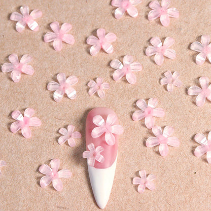 Elegant 3D flower nail charms in white and pink colours, featuring a transparent jelly finish and rhinestone accents for a stylish manicure