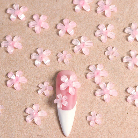 Elegant 3D flower nail charms in white and pink colours, featuring a transparent jelly finish and rhinestone accents for a stylish manicure