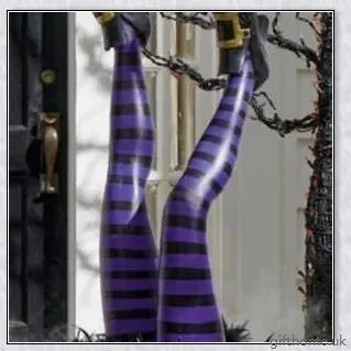 Animated witch legs in various colours, including purple, yellow, and black and white, kicking and moving to create a spooky Halloween display