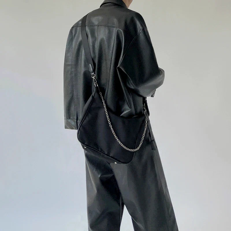Stylish black crossbody bag with a British-inspired design, featuring a spacious interior and comfortable single-strap for hands-free convenience.
