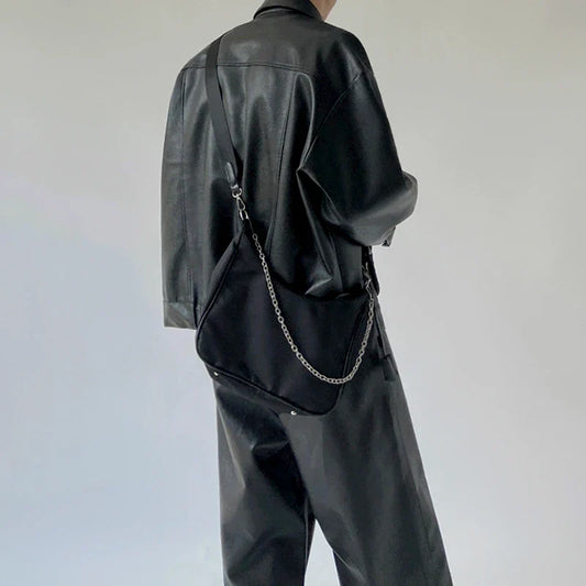 Stylish black crossbody bag with a British-inspired design, featuring a spacious interior and comfortable single-strap for hands-free convenience.