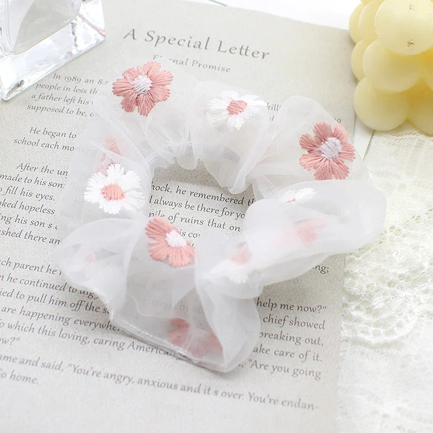 Handmade floral elastic hair bands with soft chiffon fabric and vibrant embroidered daisy patterns, perfect for enhancing everyday style in the UK.