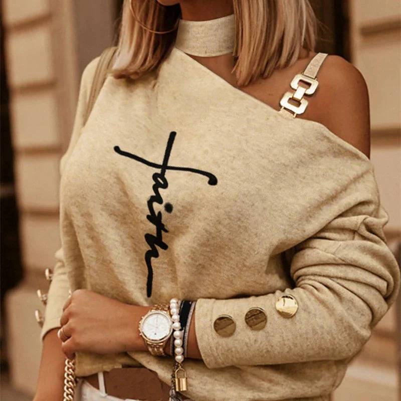 Stylish long sleeve top with diagonal shoulder chain embellishment in black, navy, and burgundy colours