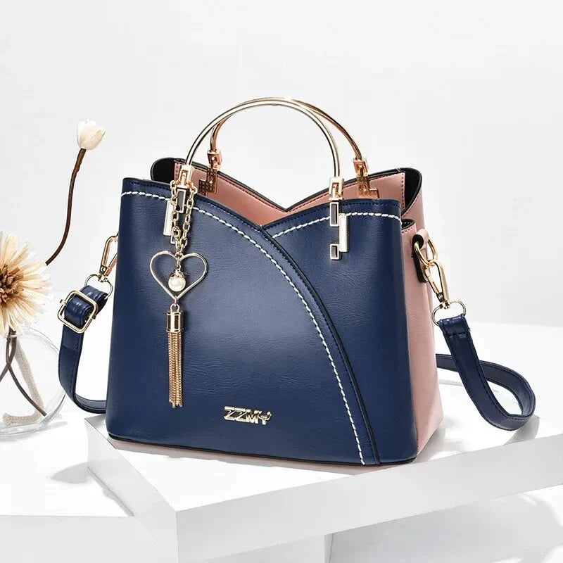 Sophisticated navy blue PU leather bucket crossbody bag with elegant patchwork design and adjustable strap