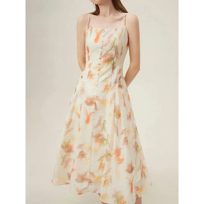 Floral sleeveless summer dress with A-line silhouette and vibrant orange print, perfect for British summer occasions