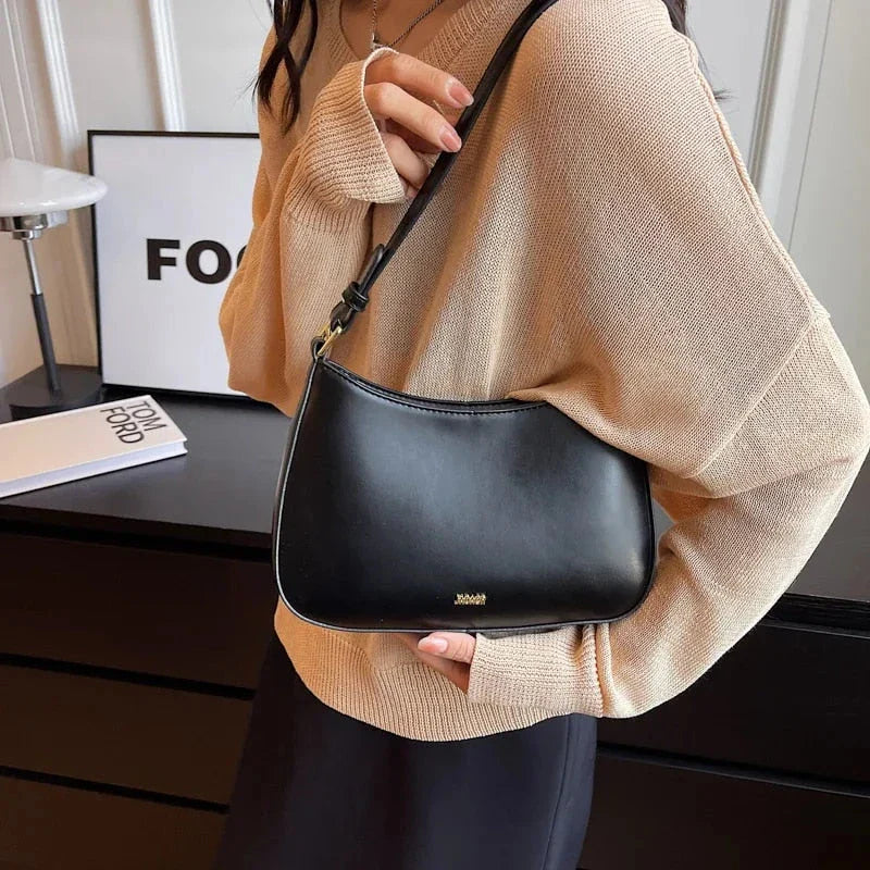 Luxury red leather crossbody bag with sleek design and elegant details
