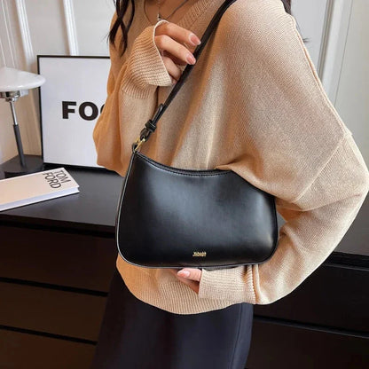 Luxury red leather crossbody bag with sleek design and elegant details