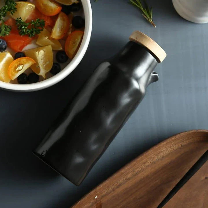 Premium black ceramic oil dispenser with a sleek and modern design, perfect for drizzling oils, vinegars, and sauces in the kitchen.