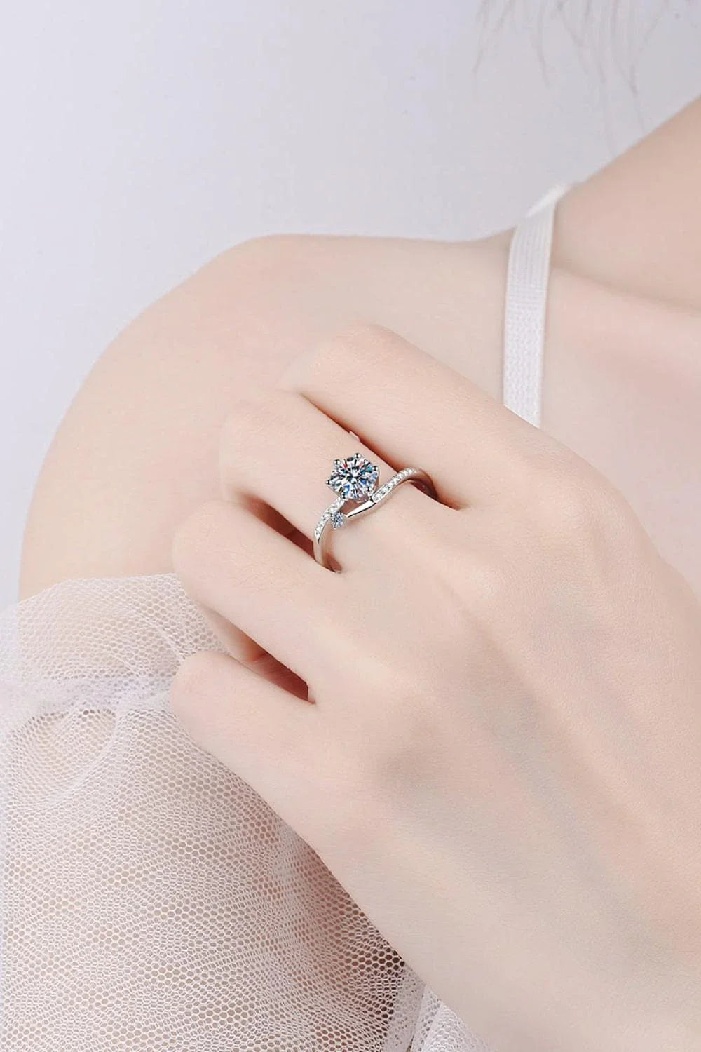 Elegant Moissanite and Sterling Silver Ring with a sparkling centre stone, delicate zircon accents, and a luxurious 925 sterling silver setting