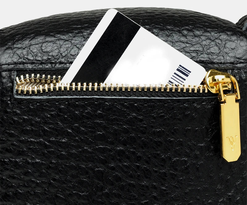 Elegant leather crossbody bag with adjustable strap, multiple pockets, and premium cowhide construction for the modern British woman