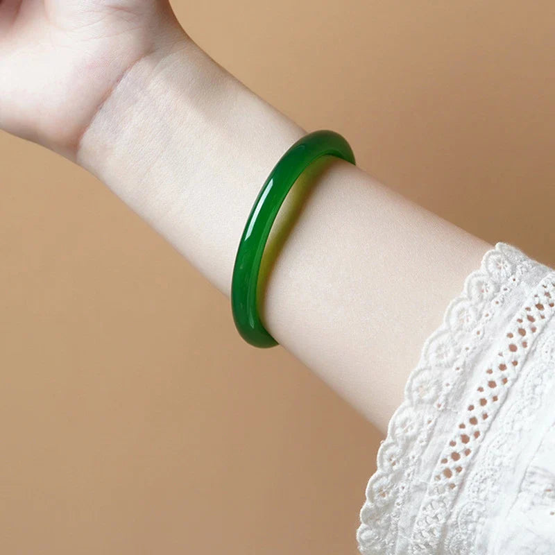 Stylish agate chalcedony bracelet with jingle bell charm in classic green hues