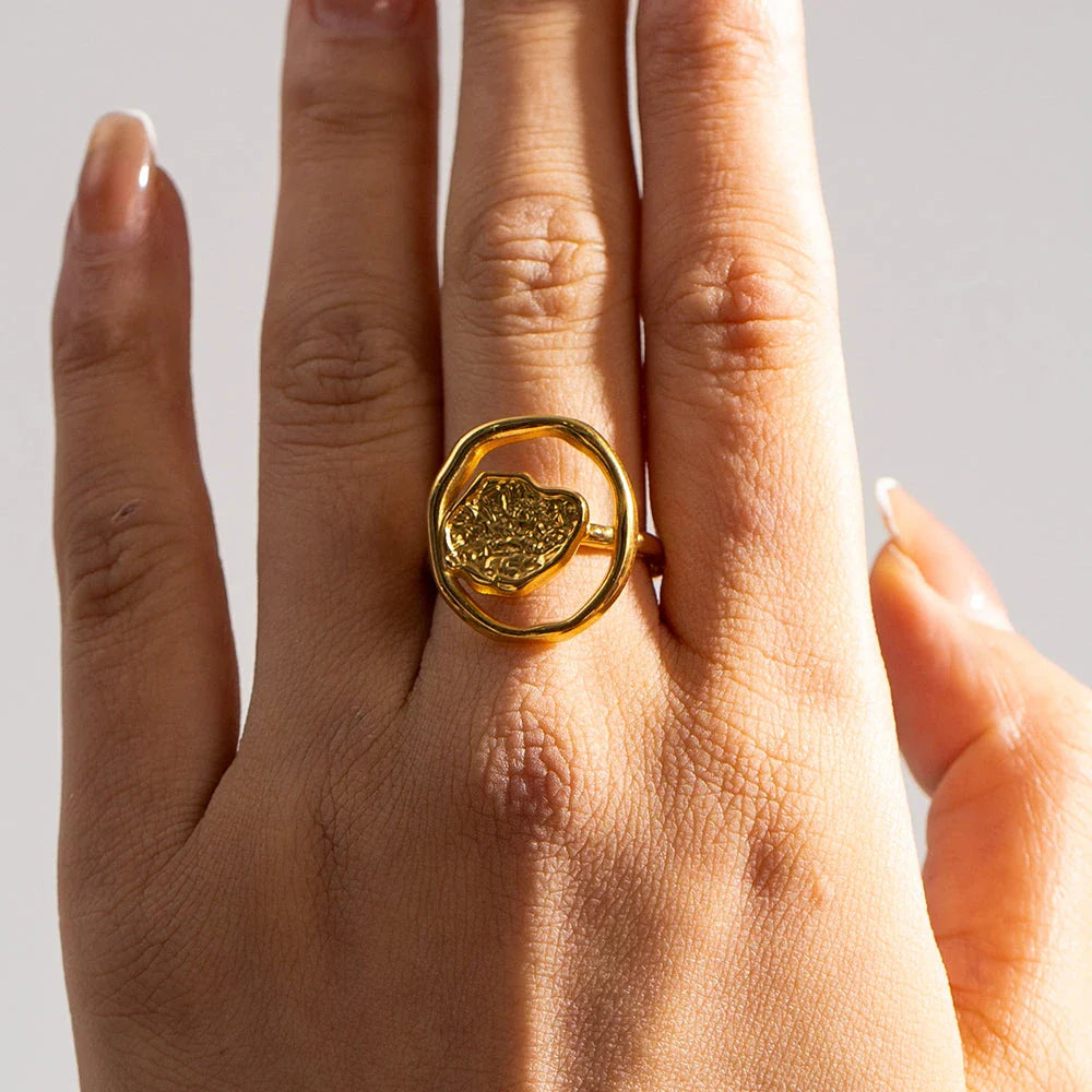 Elegant 18K gold-plated stainless steel ring with intricate hollow-carved design and vintage-inspired charm