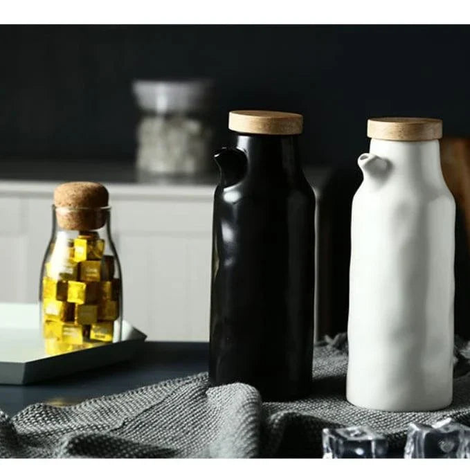 Premium black ceramic oil dispenser with a sleek and modern design, perfect for drizzling oils, vinegars, and sauces in the kitchen.