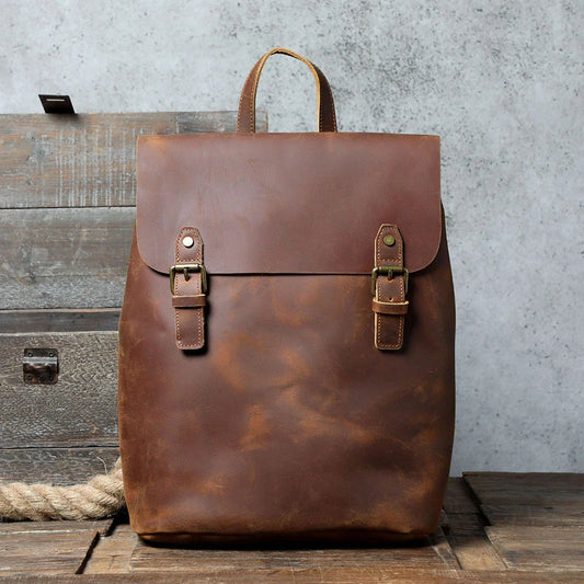 Premium vintage leather backpack with a classic design, featuring a spacious main compartment and adjustable padded shoulder straps for comfortable wear.