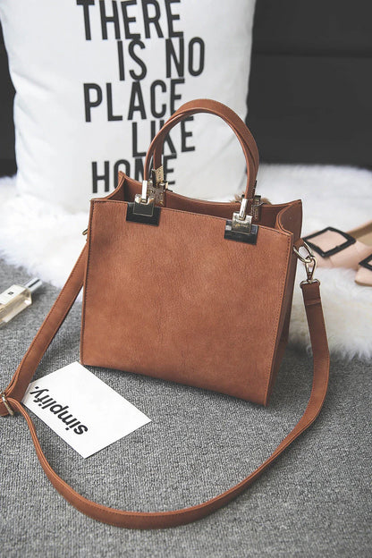A stylish and versatile shoulder bag with a pom-pom accent, perfect for everyday use and special occasions.