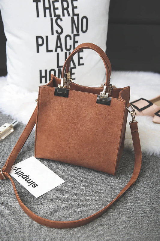 A stylish and versatile shoulder bag with a pom-pom accent, perfect for everyday use and special occasions.