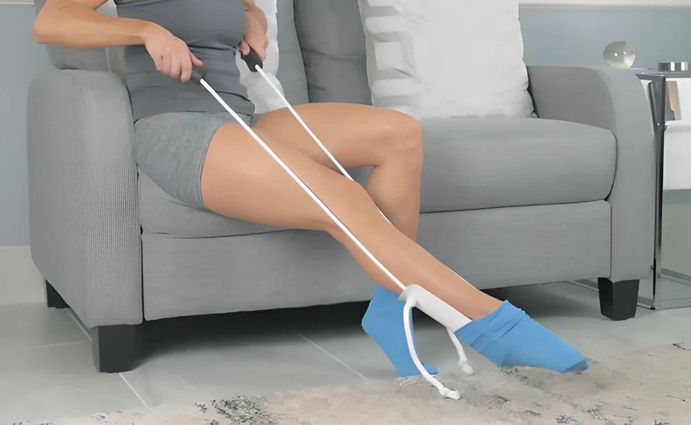 Ergonomic sock puller aid with soft, flexible shell and adjustable cord for easy sock-wearing