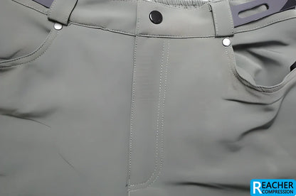 Men's cycling shorts in black and green colours, with adjustable waistband and zipper pockets for storage