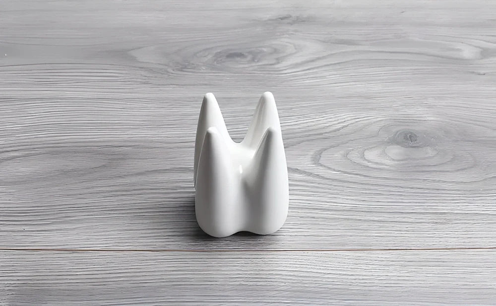 Ceramic succulent planter pot with unique tooth-shaped design, available in white, grey, and black colours