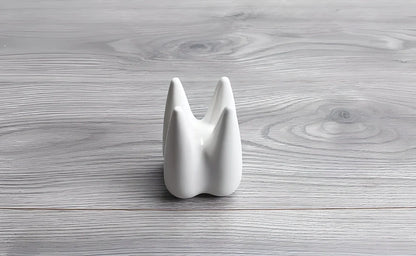 Ceramic succulent planter pot with unique tooth-shaped design, available in white, grey, and black colours