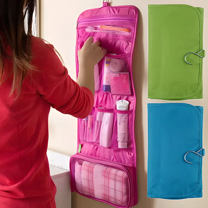 A folding travel toiletry organiser made of polyester, available in red, blue, and green colours